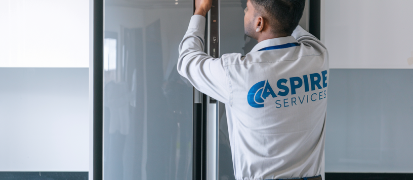 Aspire Services technician inspecting a side-by-side refrigerator for troubleshooting and repairs.